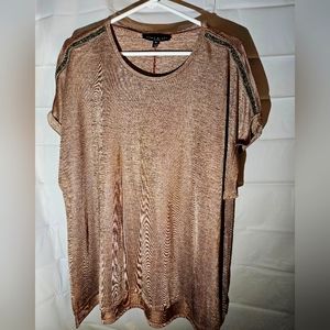 3X Gold shirt with sparkle accents on the shoulders.